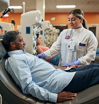 Donor in chair speaking to nurse