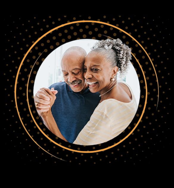 Senior couple dancing and smiling together in a loving embrace.