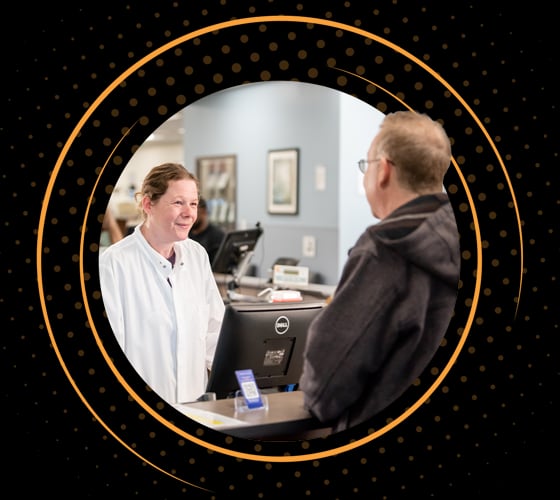 A smiling BioLife healthcare professional checking in a donor for their scheduled appointment.